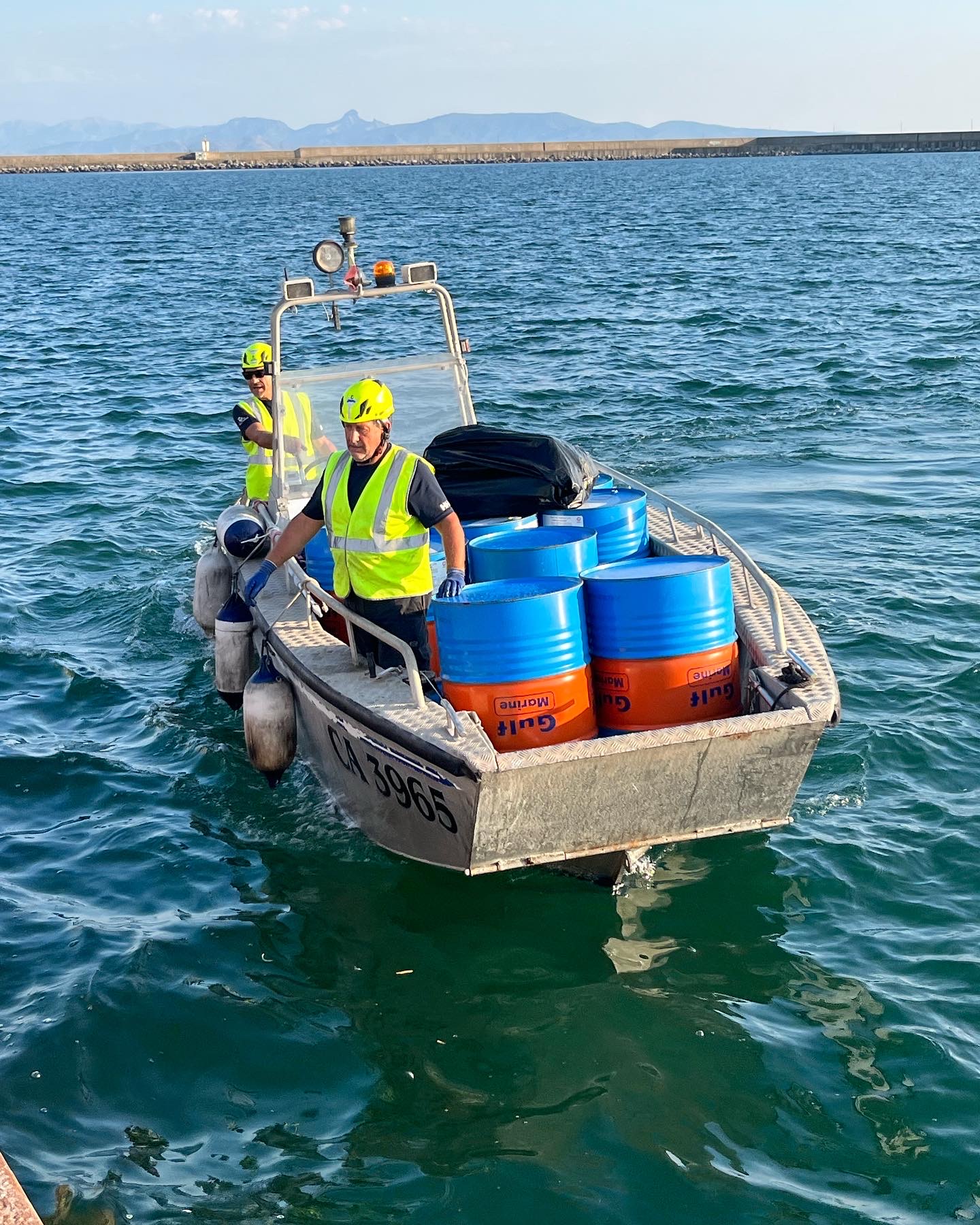 Response team handling an oil containment boom